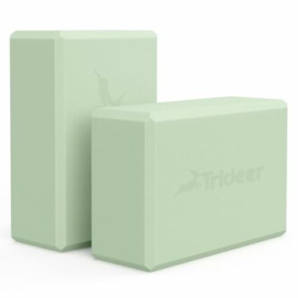 Two green yoga blocks with brand logo.