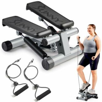 Woman exercising on a mini stepper with resistance bands.